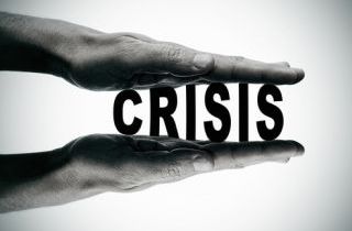 man hands pressing the word crisis, in black and white