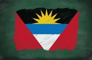 Antigua and Barbuda flag painted with color chalk on old blackboard