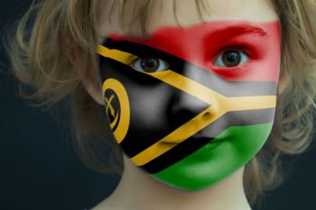 Portrait of a child with a painted Vanuatu flag on her face, closeup. vanuatu