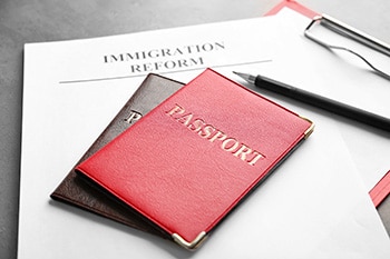 Passports and sheet of paper with words IMMIGRATION REFORM on ta Grindelwald - Suiza