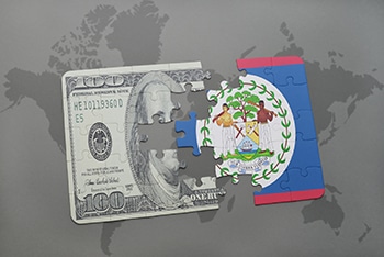 puzzle with the national flag of belize and dollar banknote on a world map background. Grindelwald - Suiza